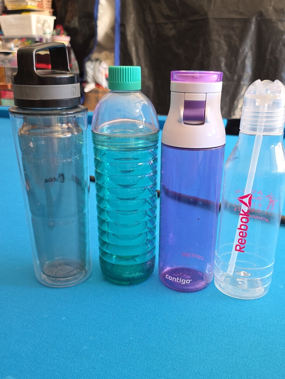 Set of 4 reusable water bottles in different sizes and styles.